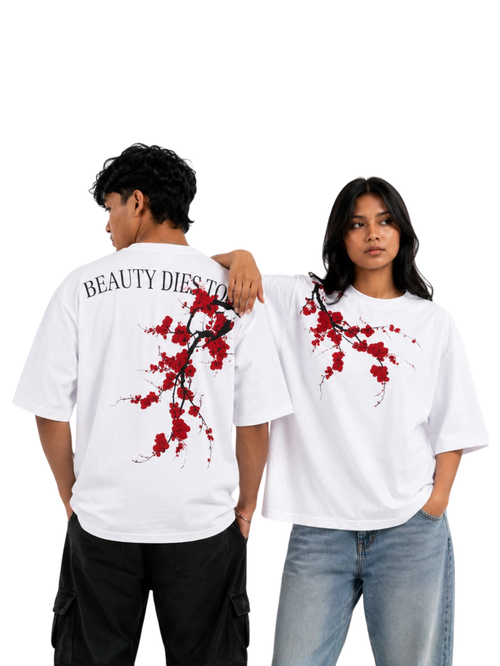 Male and female models wearing Beauty Dies Too oversized white t-shirt featuring floral shoulder artwork and statement back graphic
