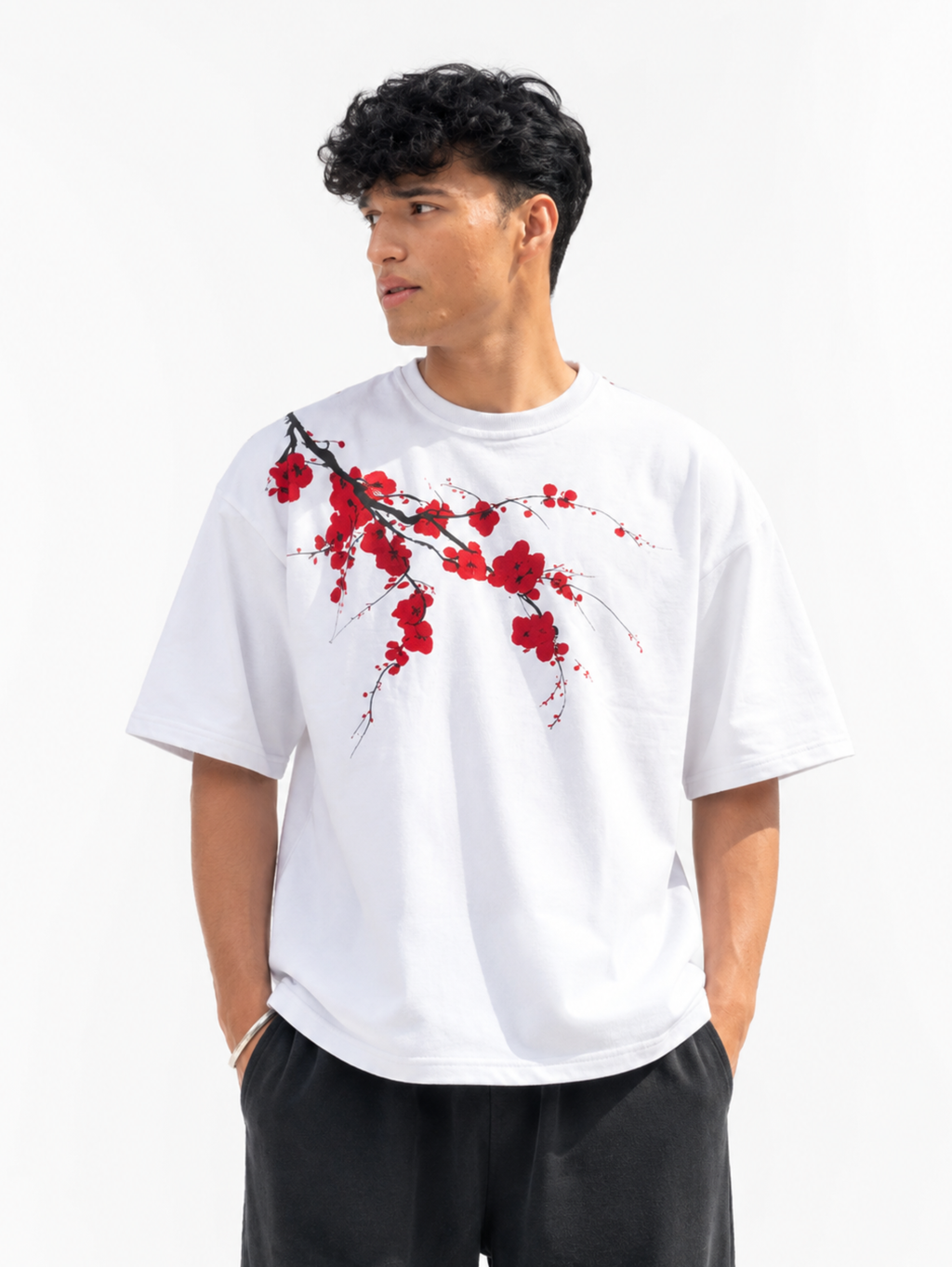Male model wearing Beauty Dies Too oversized white graphic t-shirt with asymmetrical floral print