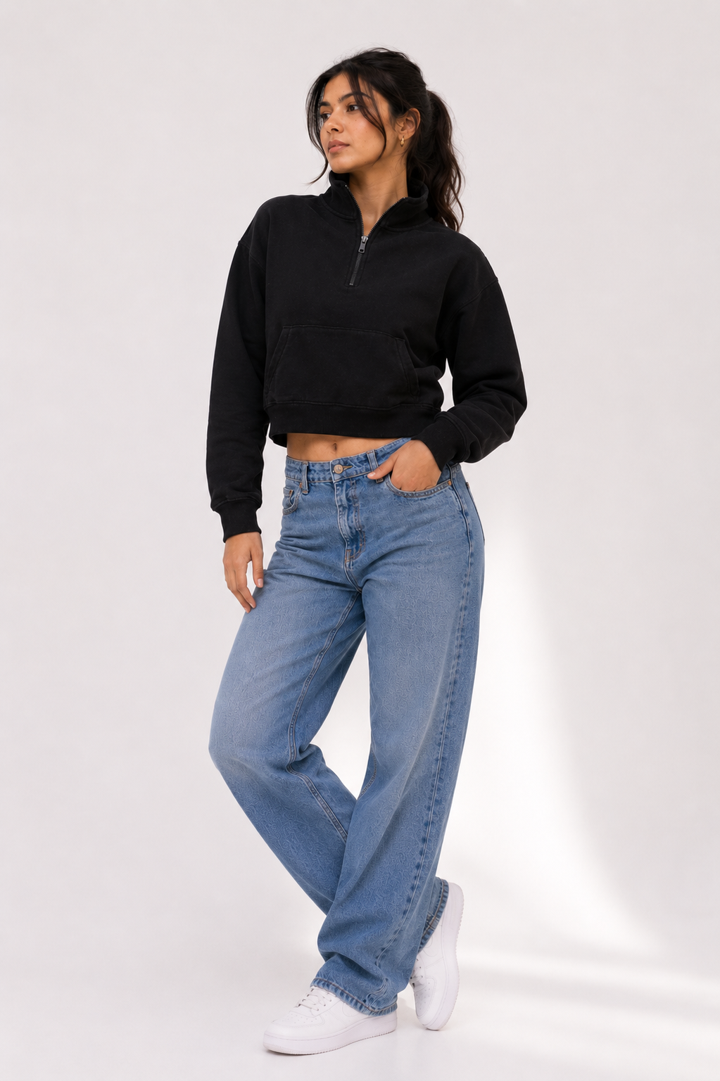 Female model wearing the Black Crop Zipper with light blue wide-leg denim, showcasing the relaxed cropped fit and minimalist design.
