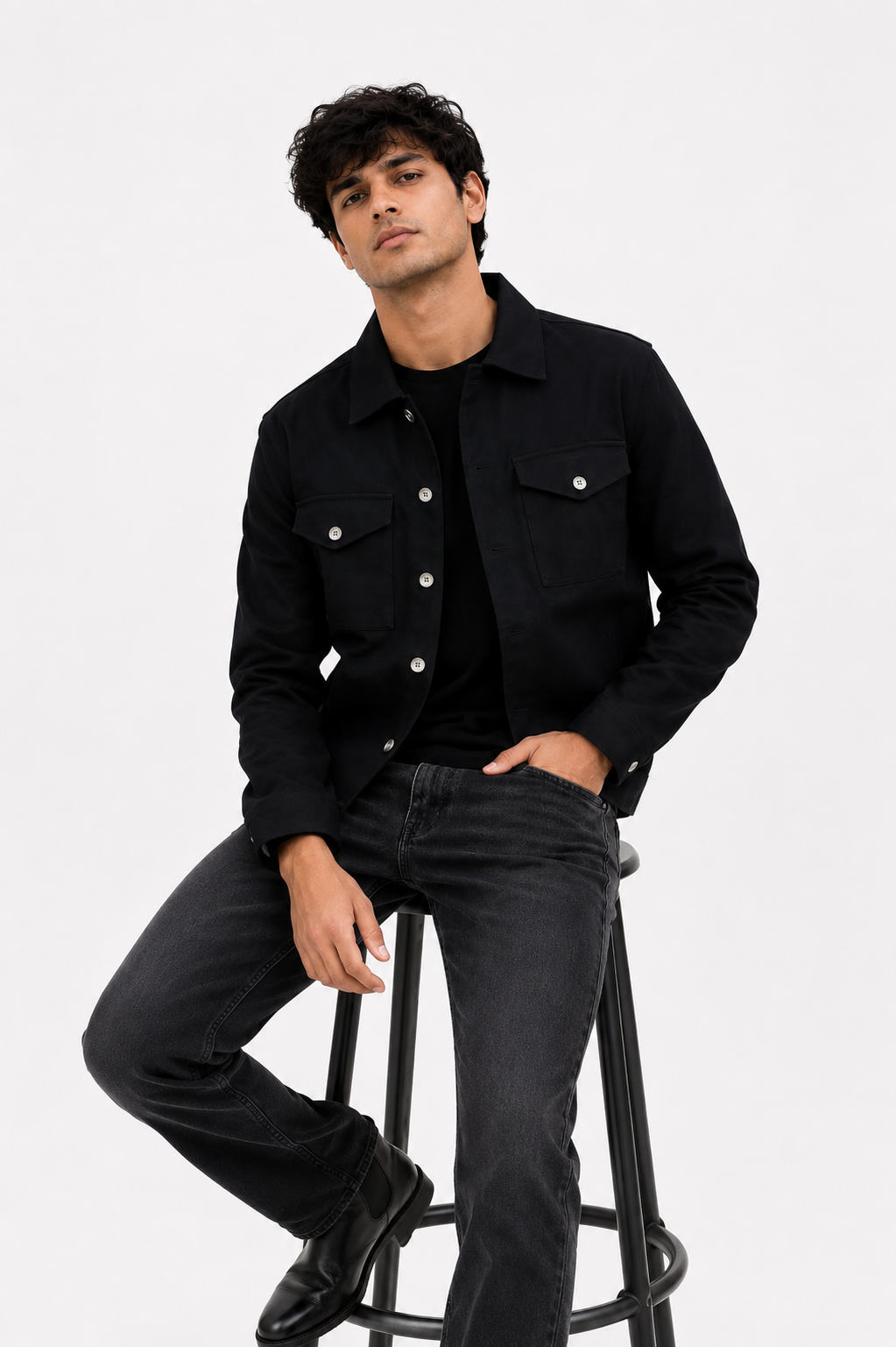 Male model wearing the Black Denim Jacket styled with a black t-shirt, washed black jeans, and a minimal monochrome outfit.