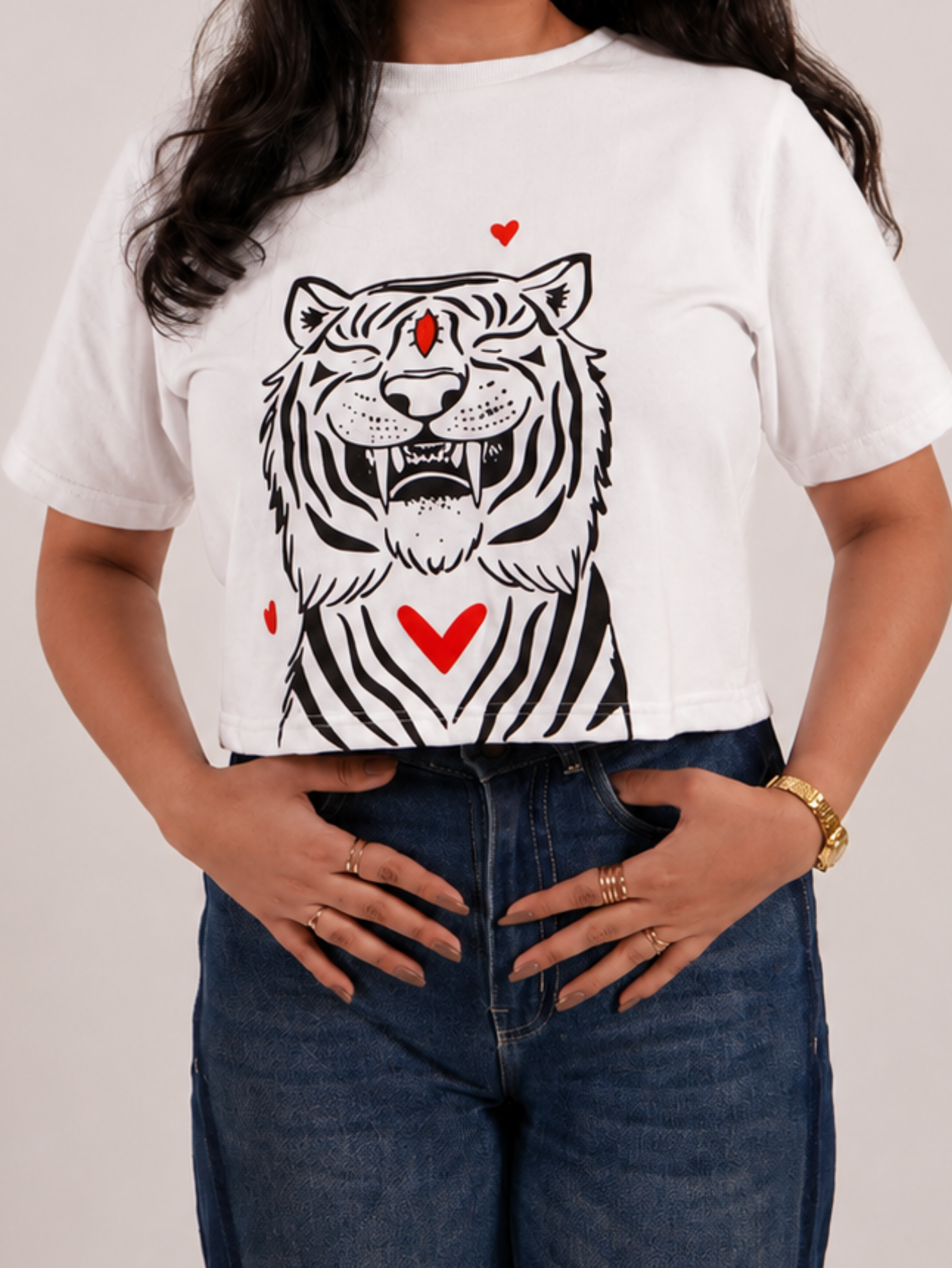 Full-length view of Fierce & Fluffy white crop top styled with blue denim jeans