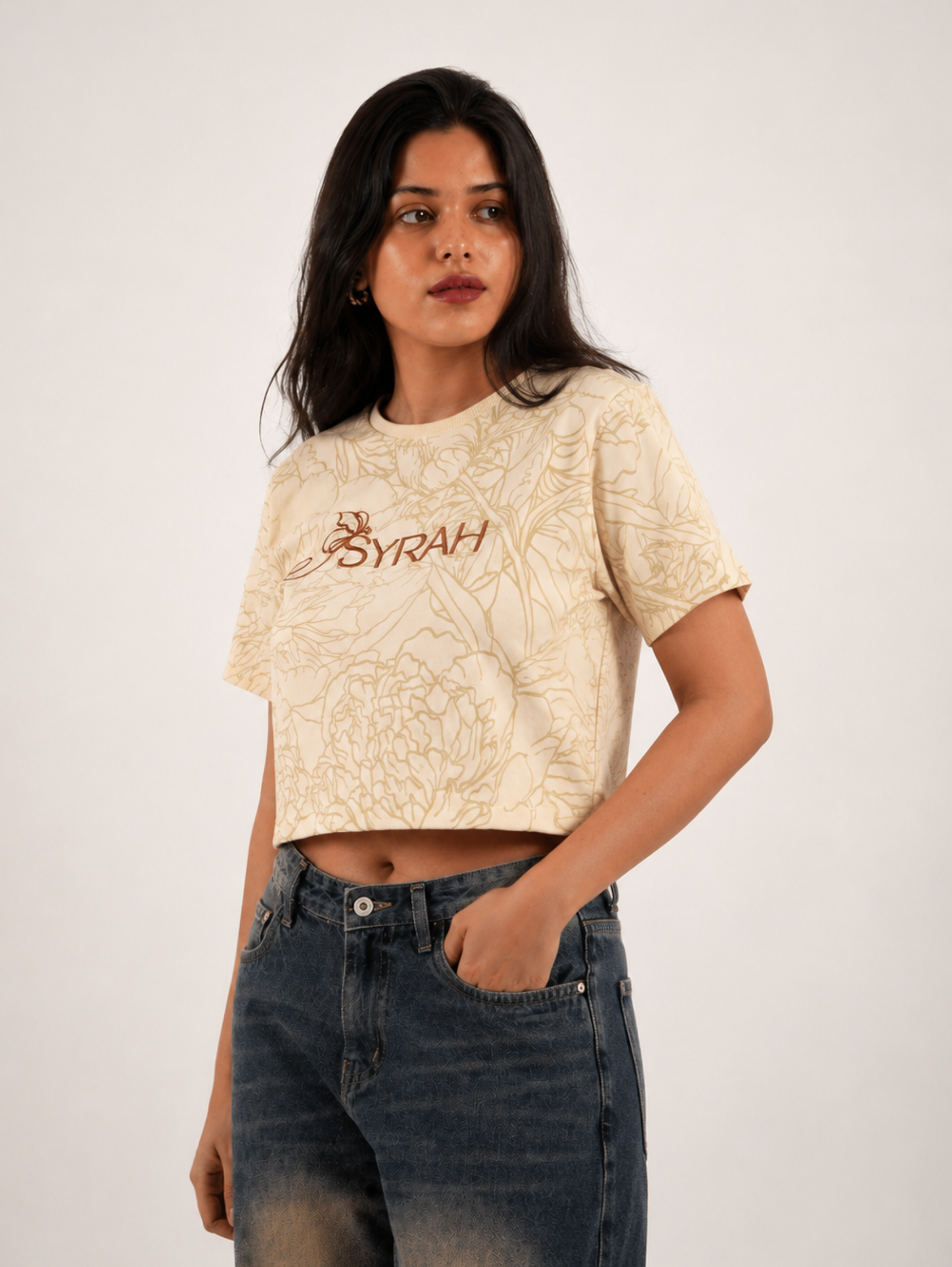 Female model wearing Golden Bloom cream floral crop top with denim jeans