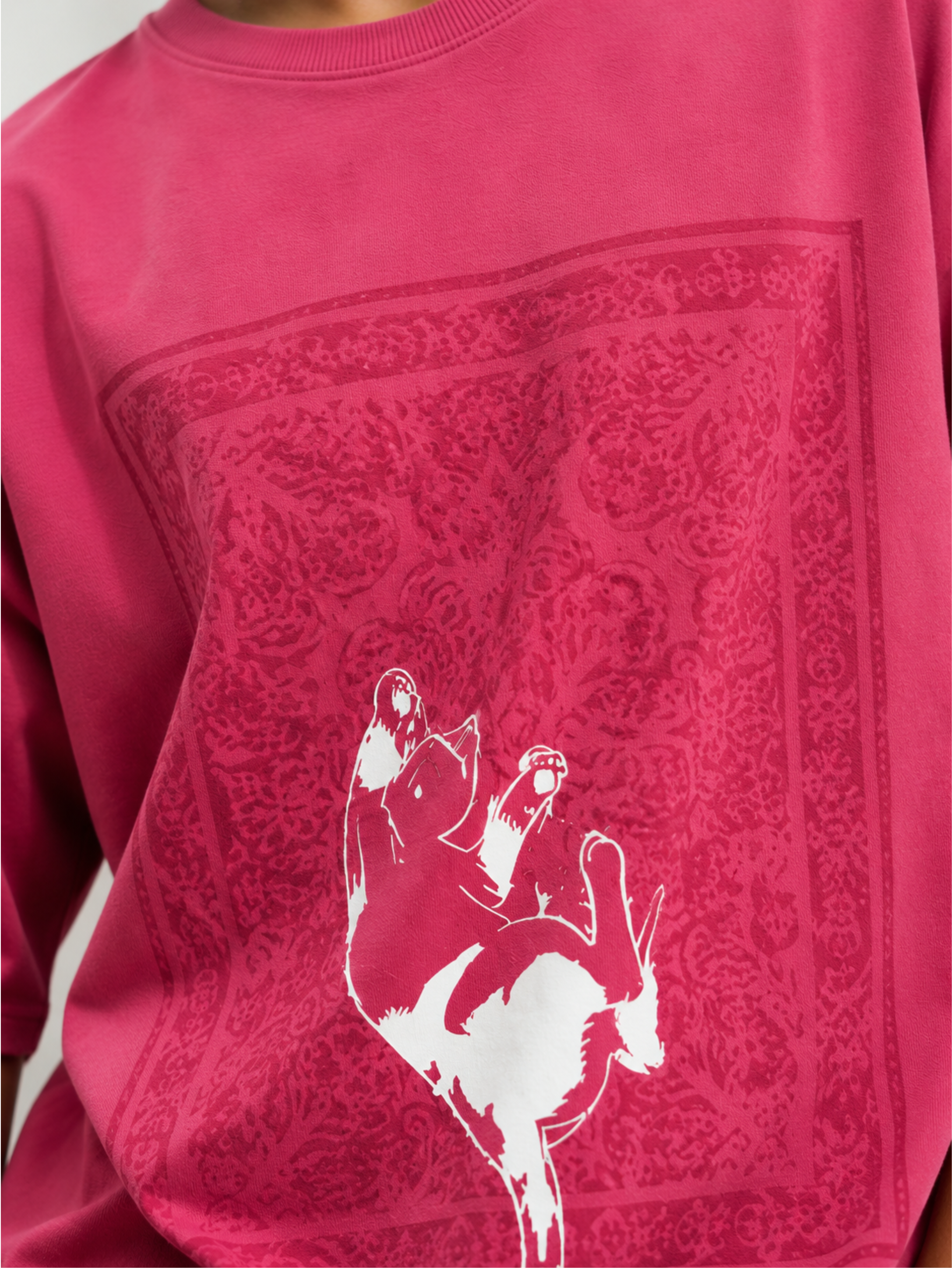 Close-up of the Mid Air Myth oversized pink cotton T-shirt by SYIN & SYRAH showcasing the detailed Persian rug artwork, falling cat graphic, premium fabric texture, and high-quality screen print.