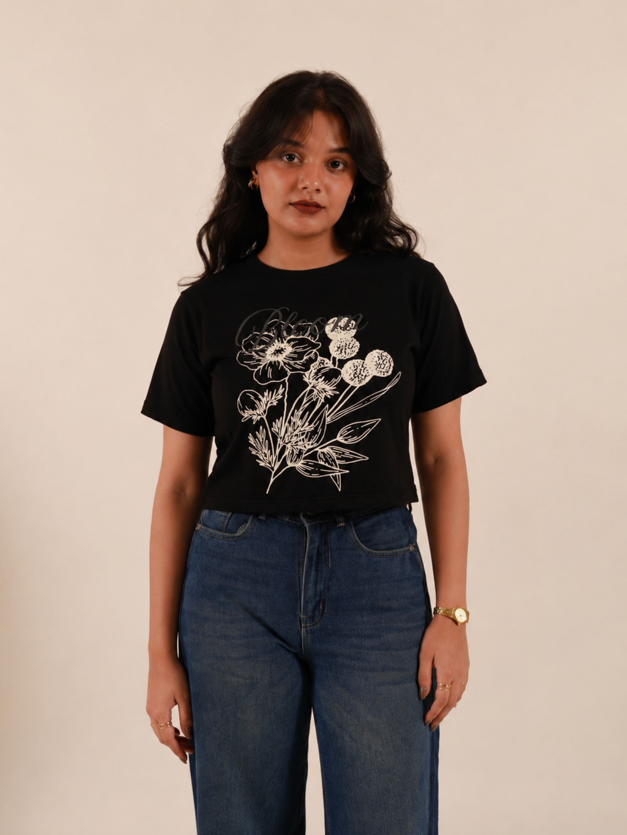 Female model wearing Noir Bloom black crop top with elegant floral illustration