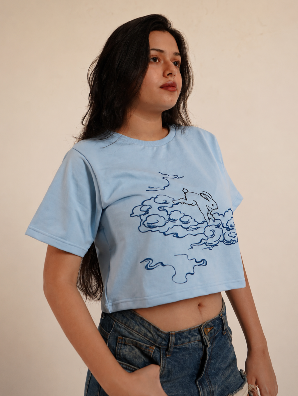 Side profile of female model wearing Puffy Dreams rabbit graphic crop top