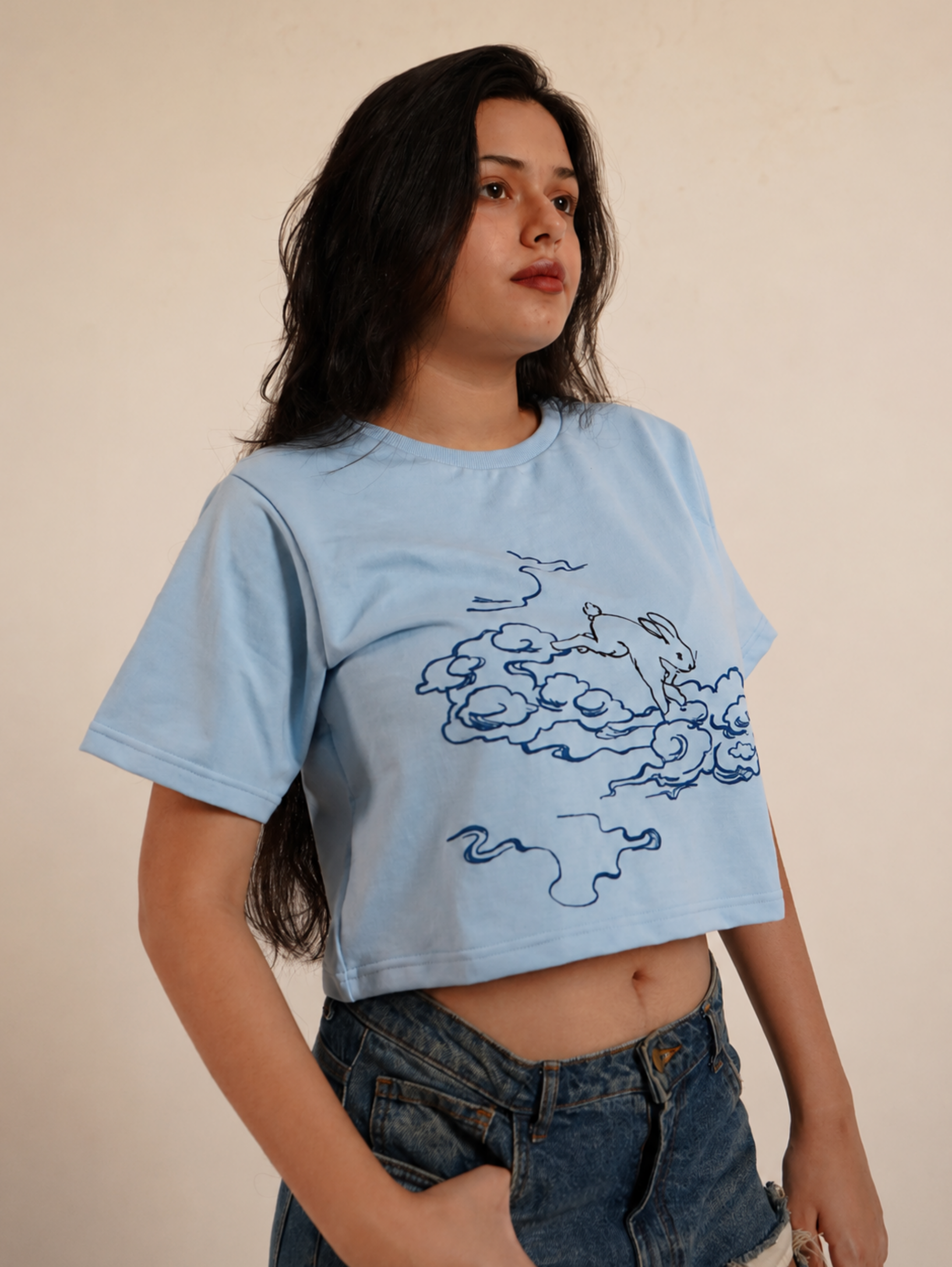 Side profile of female model wearing Puffy Dreams rabbit graphic crop top