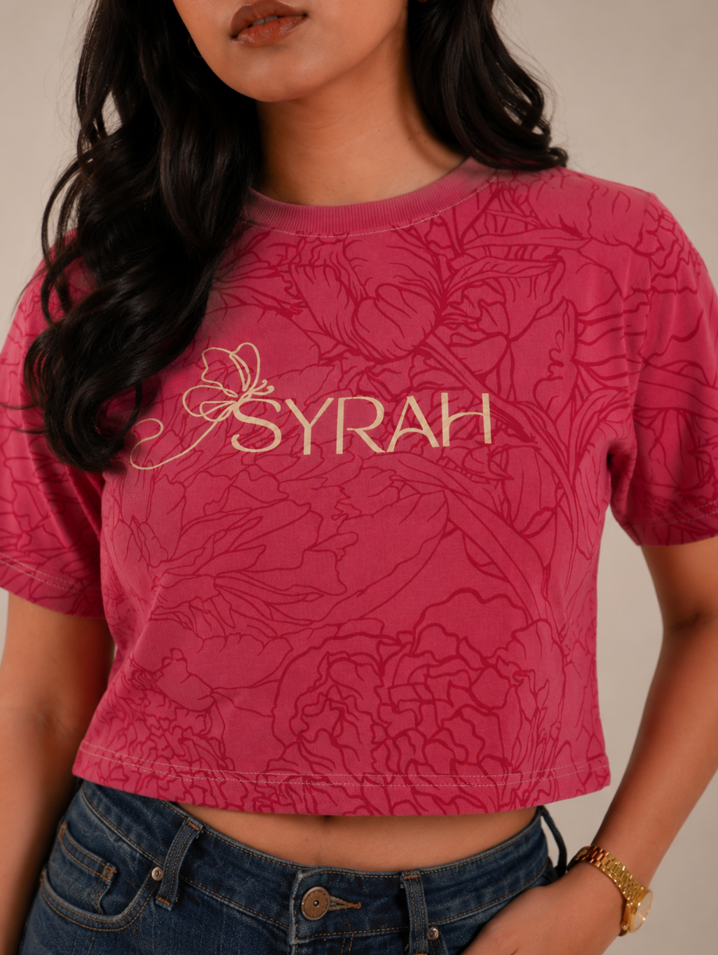 Close-up of SYRAH logo with all-over floral print on Rose Bloom crop top