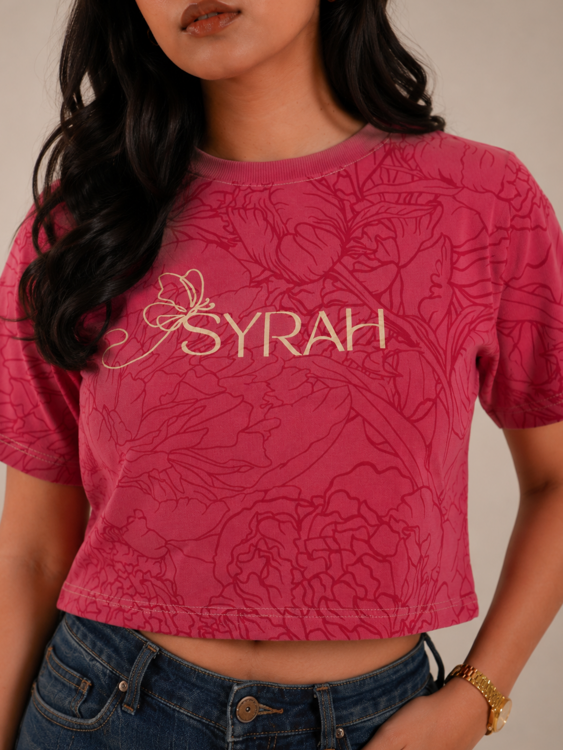 Close-up of SYRAH logo with all-over floral print on Rose Bloom crop top