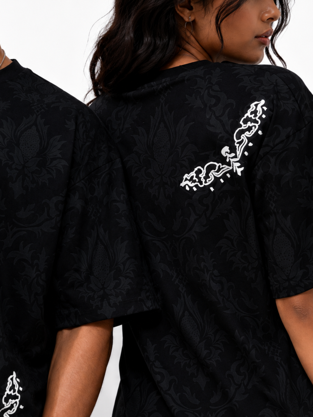 Close-up of the Shadow Moth oversized black heavyweight cotton T-shirt by SYIN & SYRAH showcasing the premium damask texture, minimalist white moth graphics, soft fabric, and high-quality screen print.
