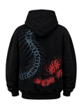 Back view of the Silken Spine oversized black hoodie featuring the anatomical spine and crimson spider lily artwork on a black background.