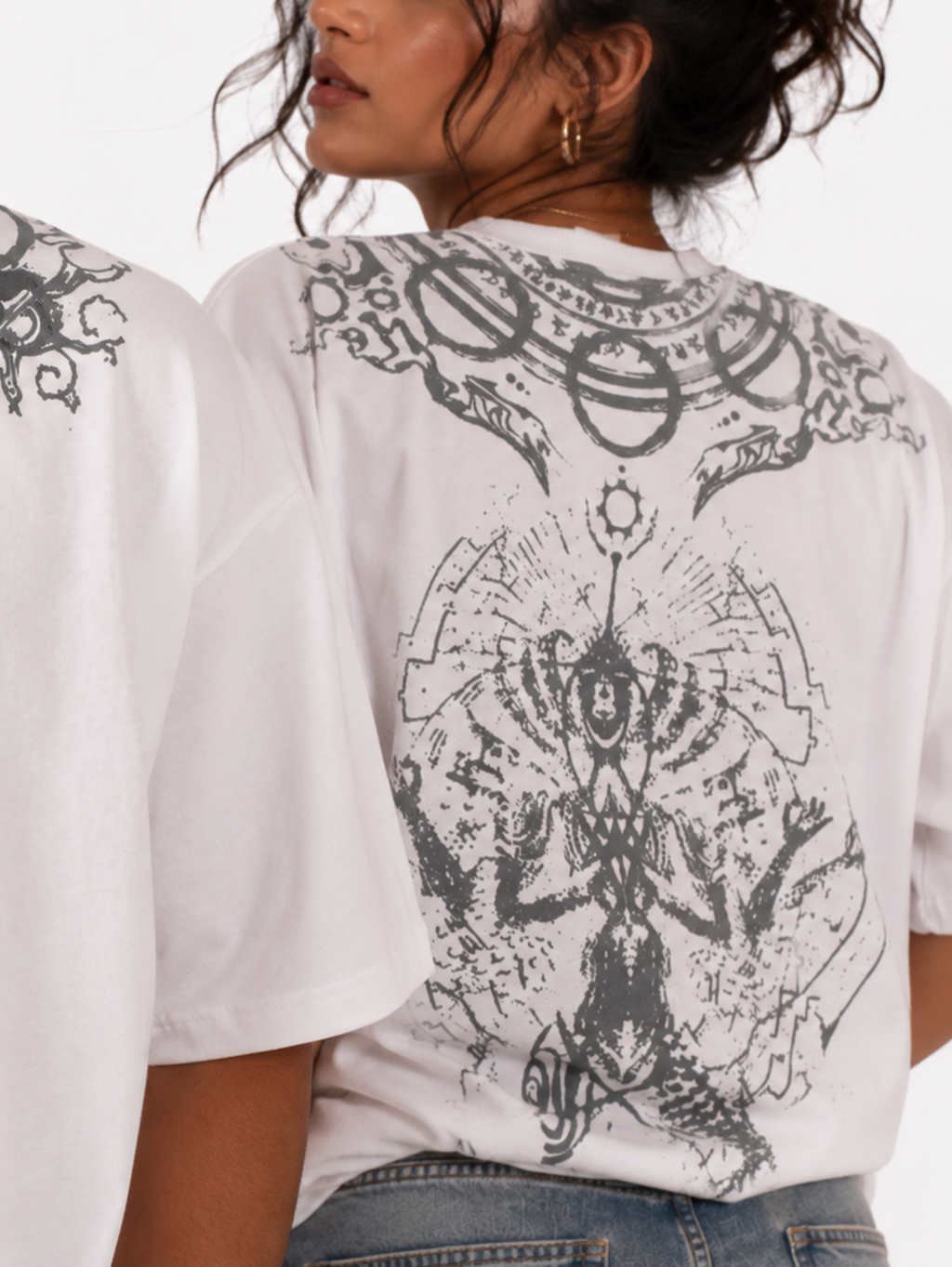 Close-up of the Vishnu Ascendent oversized white cotton T-shirt by Syin&Syrah highlighting the detailed celestial neckline print, sacred script artwork, intricate back illustration, premium fabric texture, and high-quality screen printing.