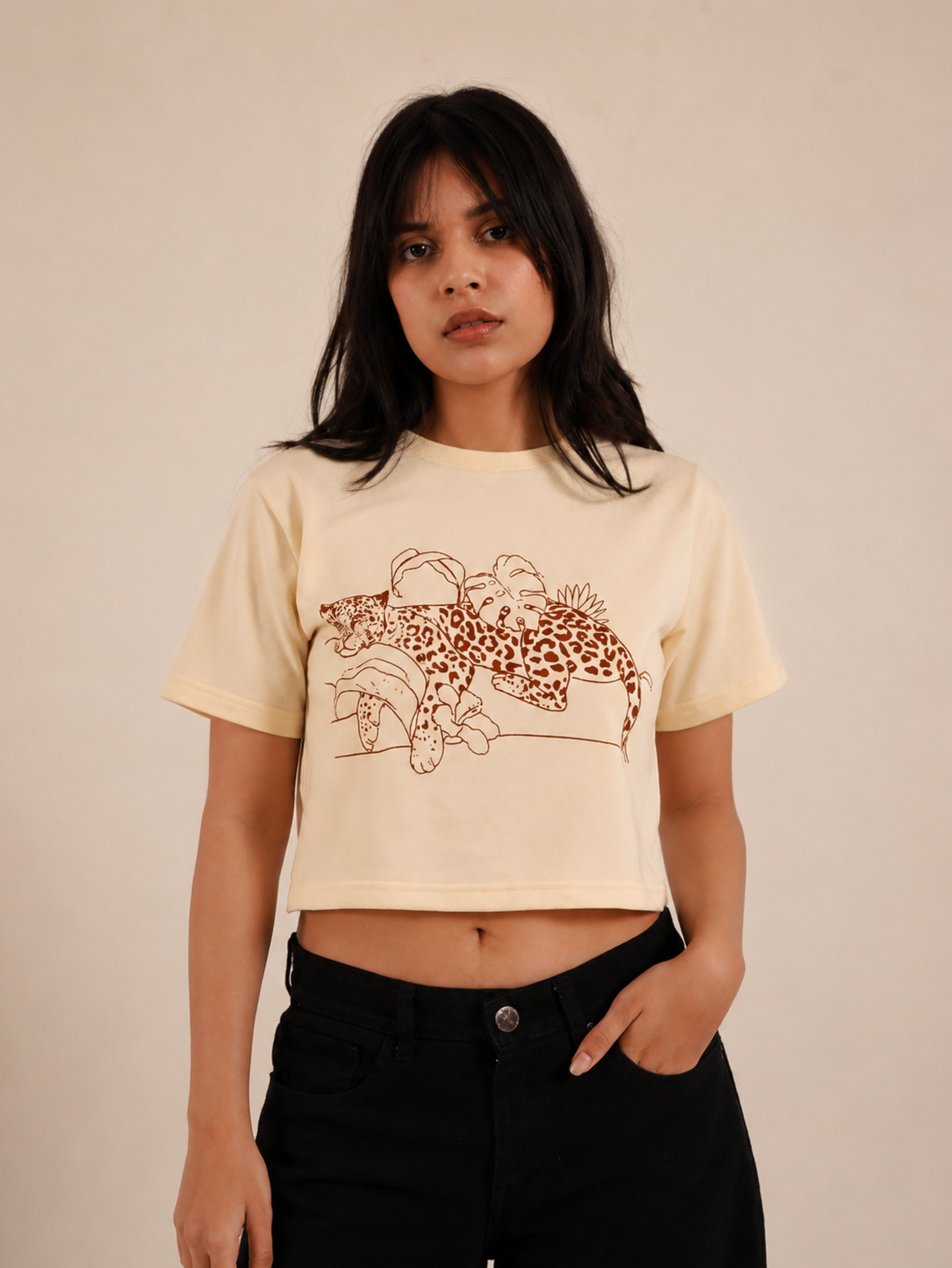 Female model styling Wild Rest premium cream crop top for everyday casual wear