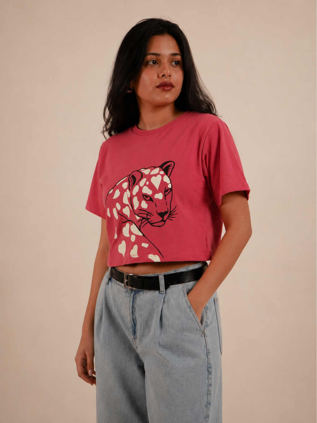 Close-up of Wild Romance leopard illustration with heart-shaped pattern on rose pink crop top